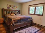 Master bedroom on the upper level with a king bed
